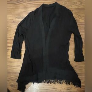 black open knit cardigan with a fringe hem